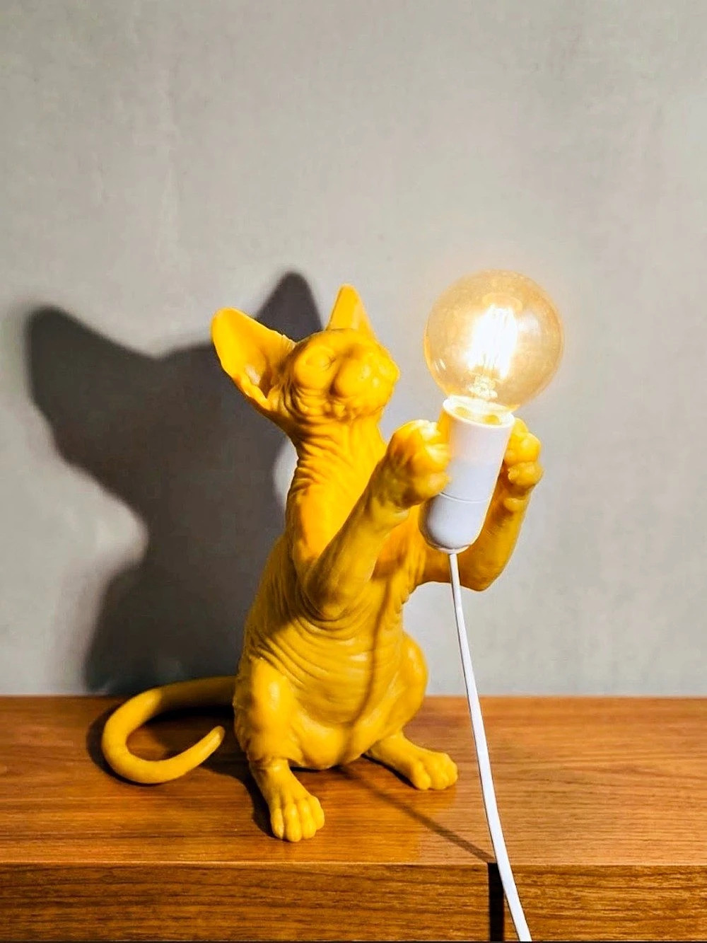 3D-printed Sphynx cat table / night lamp holding an round -style bulb